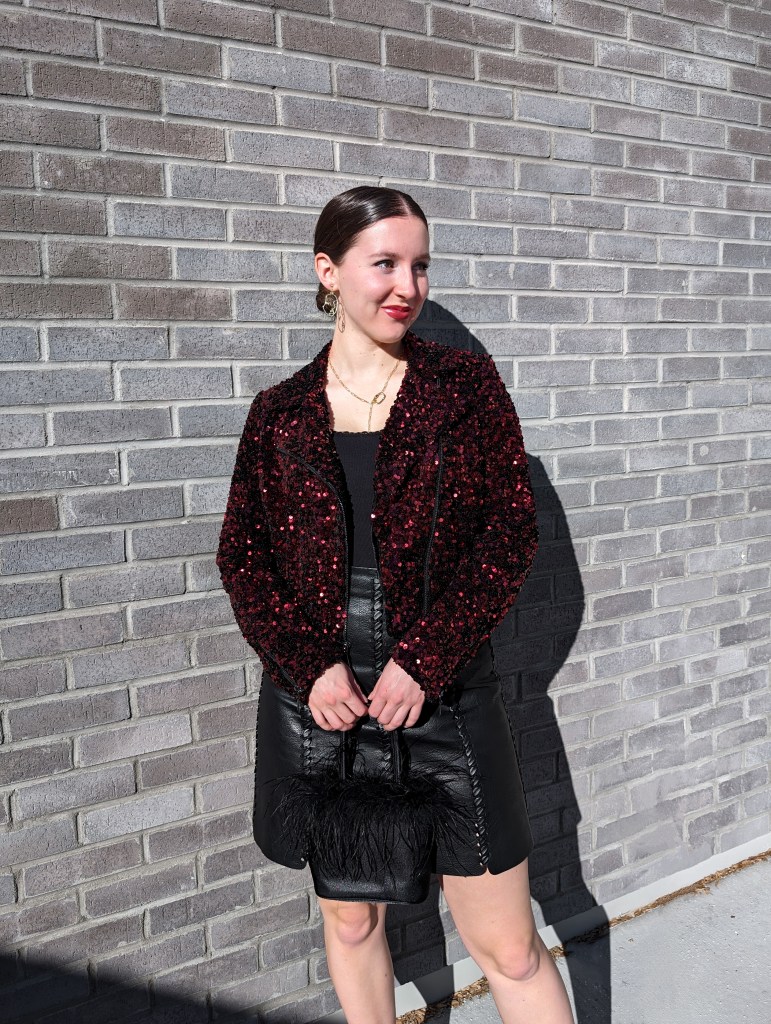 \"leather-skirt-red-sequin-jacket-black-leather-skirt-slicked-back-low-bun-red-lipstick\"